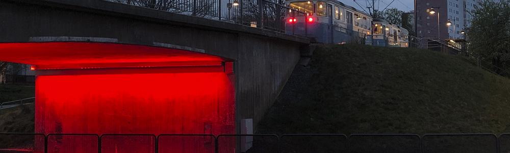 Red light reflecting a car bridge