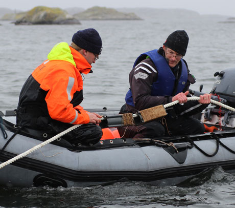 Two researchers in an inflatable boat