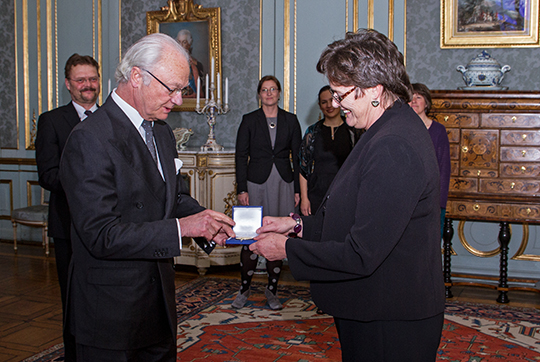 The king handing over a medal to lesley Head