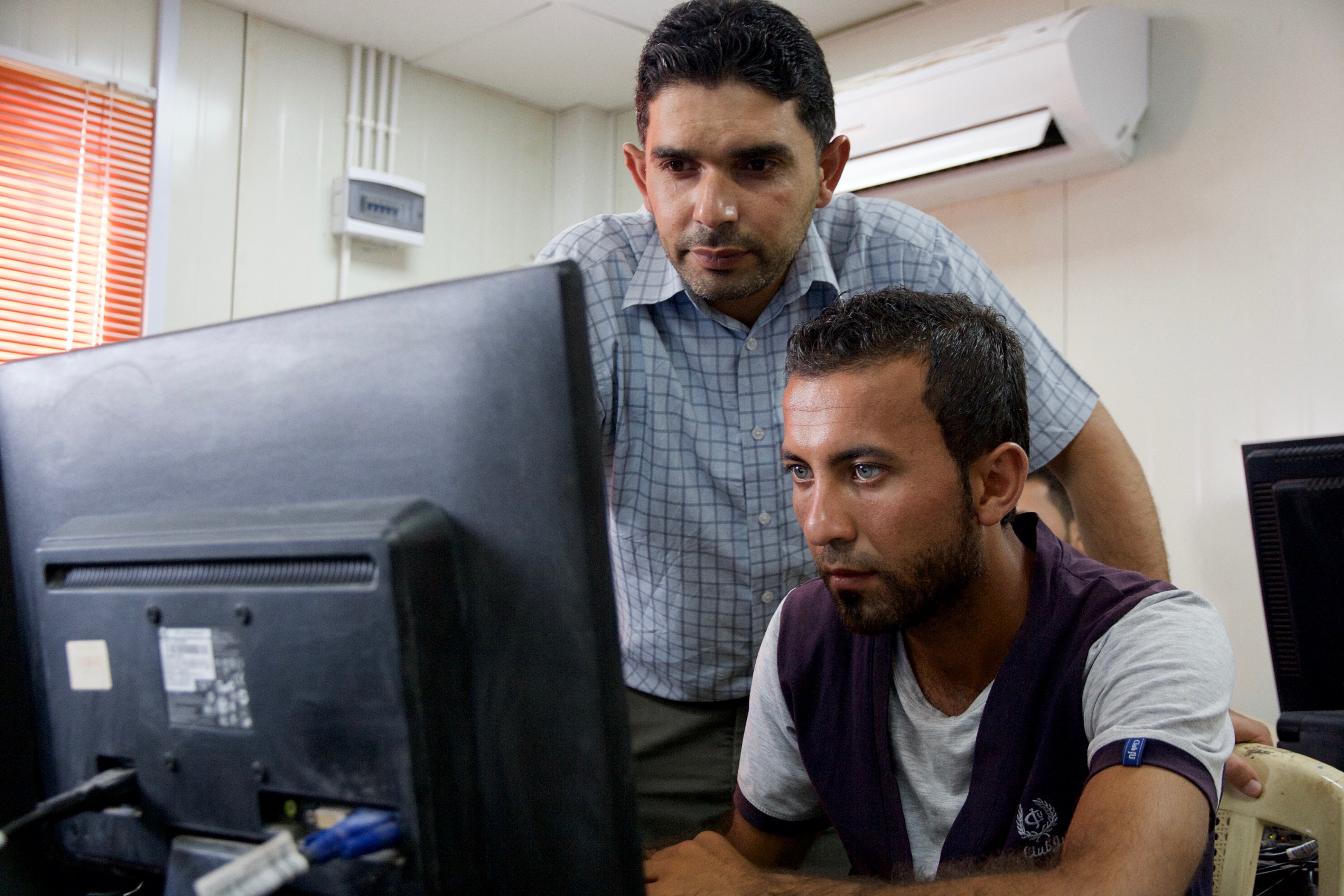 syrian local tutor with student i Zaatari refugee camp