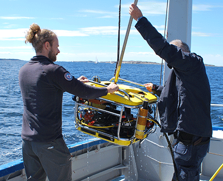 A remotely operated vehicle above the gunnel on research vessel Nereus
