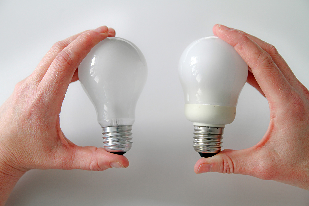 A traditional light bulb and a low-energy light bulb.