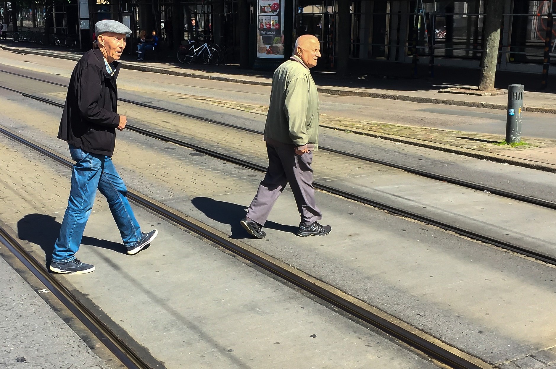 Two old men crossing a street