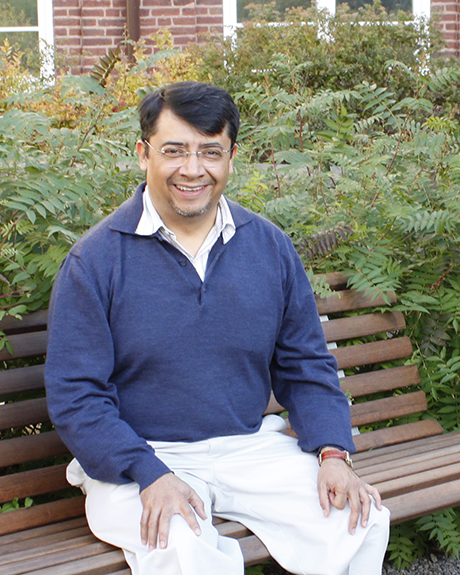 Professor Remigio Cabrera Trujillo, sitting and smiling.