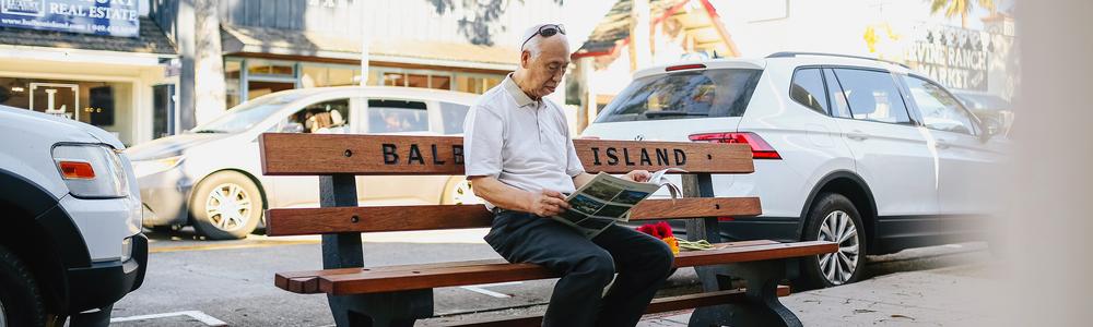 Old man sitting on a street bench.