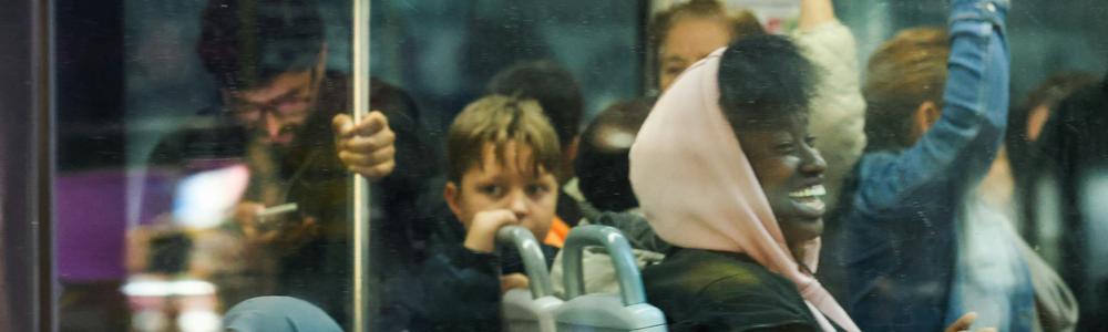 The picture shows some children and young people on a bus.