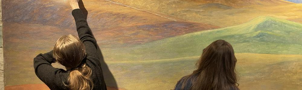 Students examining the technology of a mural painting, photo.