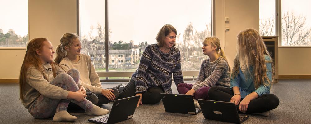 teachers talk with pupils over laptops