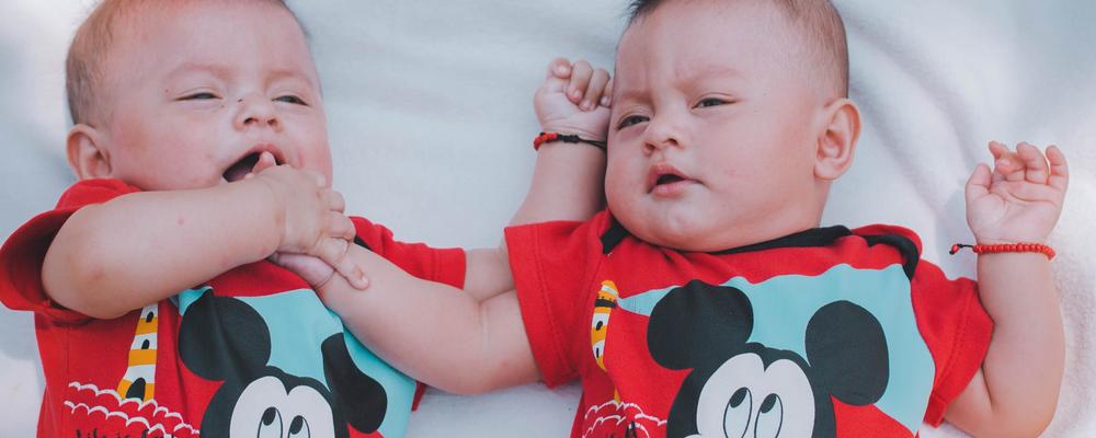 two babies wearing red mickey mouse shirt