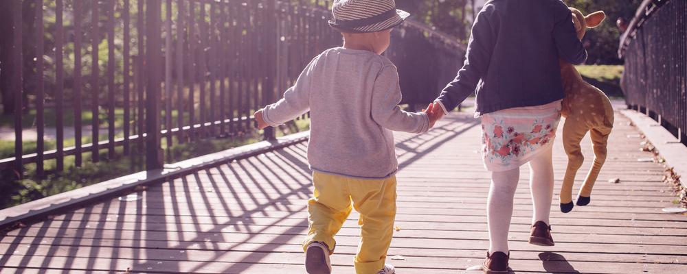 Children walking on bridge holding hands
