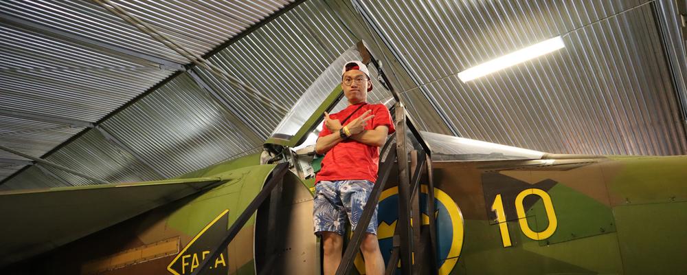 Adelric standing infront of a plane