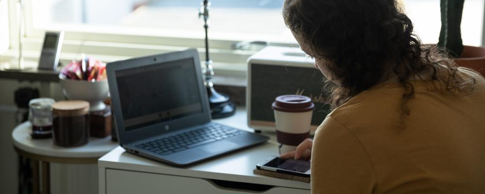 En gymnasieelever pluggar på distans från sitt rum.