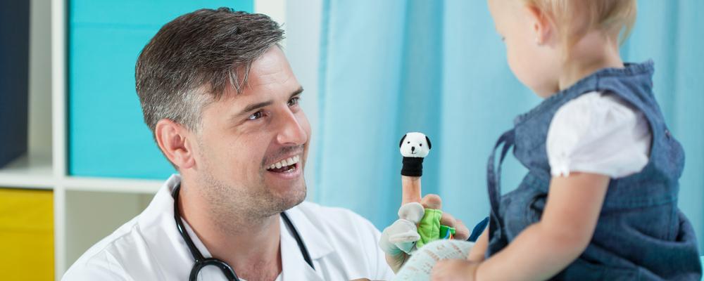 Close-up of smiling pediatrician and his little patient