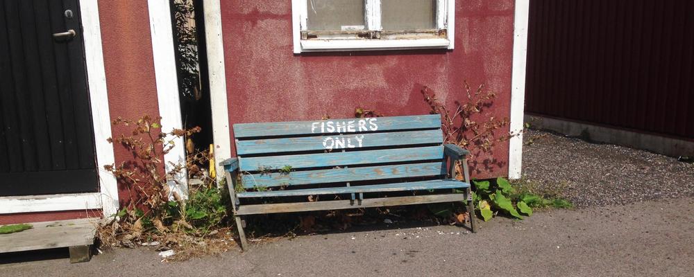 Bench with text: Fishers only.