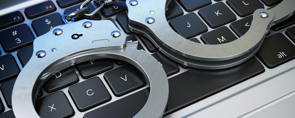 Handcuffs on the laptop keyboard