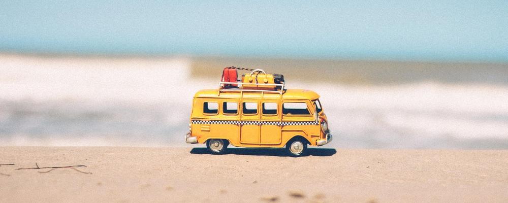 Minibus on the sand with luggage on top
