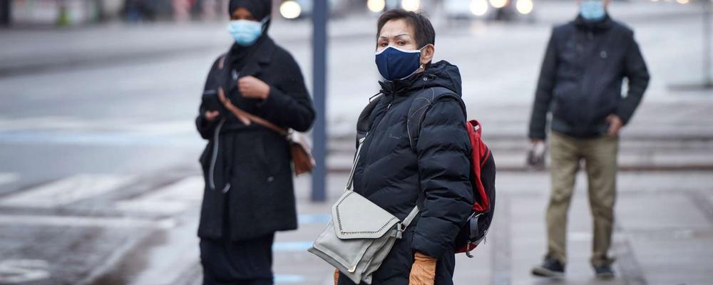 Bilden vier personer med munskydd