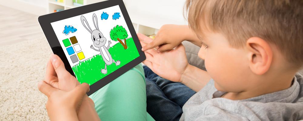Close-up Of Little Boy Playing Game On Digital Tablet
