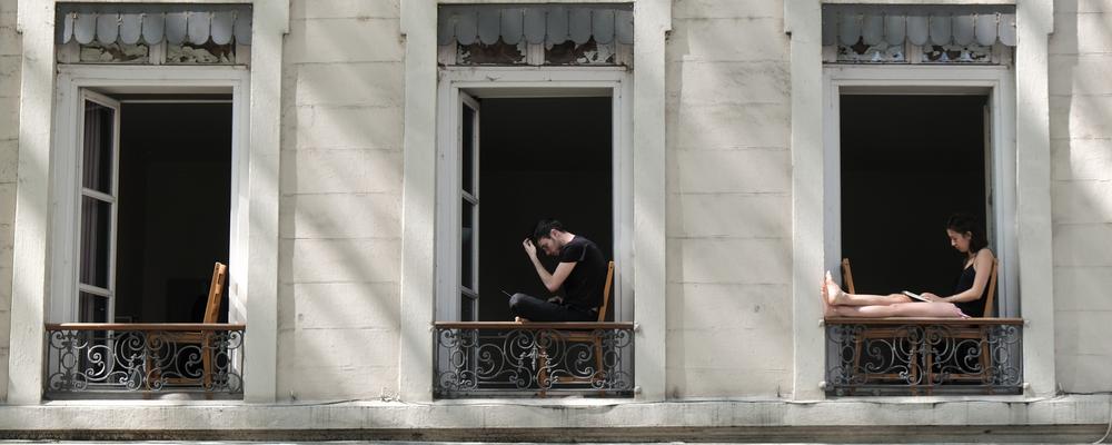 People sitting in a window during the lockdown in Lyon France, May 2020
