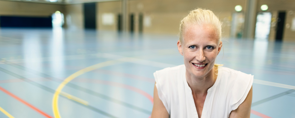 Portrait picture of Carolina Klüft, in a sports center.