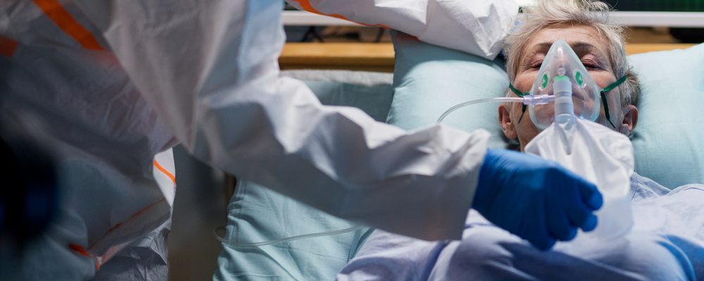 Patient in bed been taking care of at an ICU  