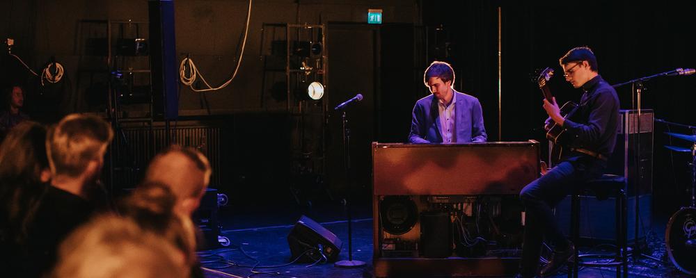 Pianist and guitar player improving on stage