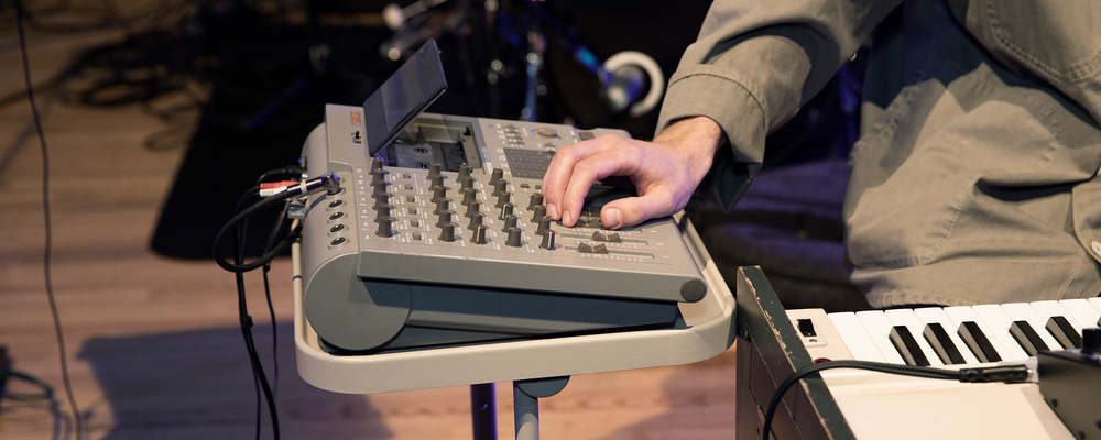 A hand touching a porta studio