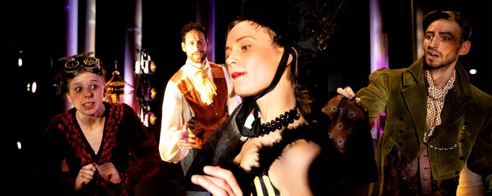 A number of persons in costume on stage