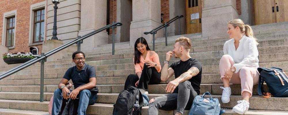 Students sitting outside on stairs and chatting