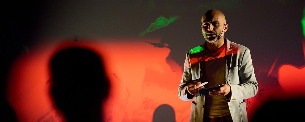 A person speaking in front of an audience. 