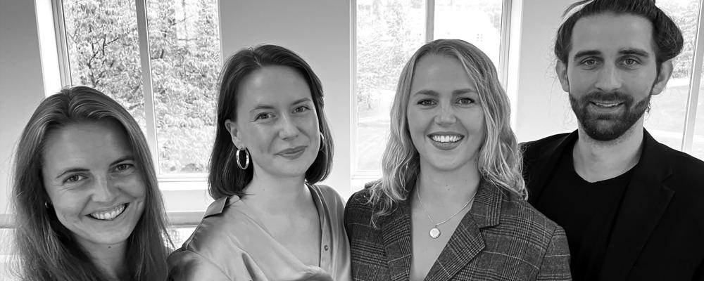 Two opera students singing on stage with arms in the air.