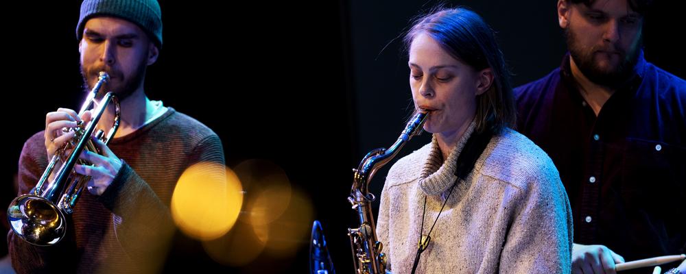 Three students playing instruments