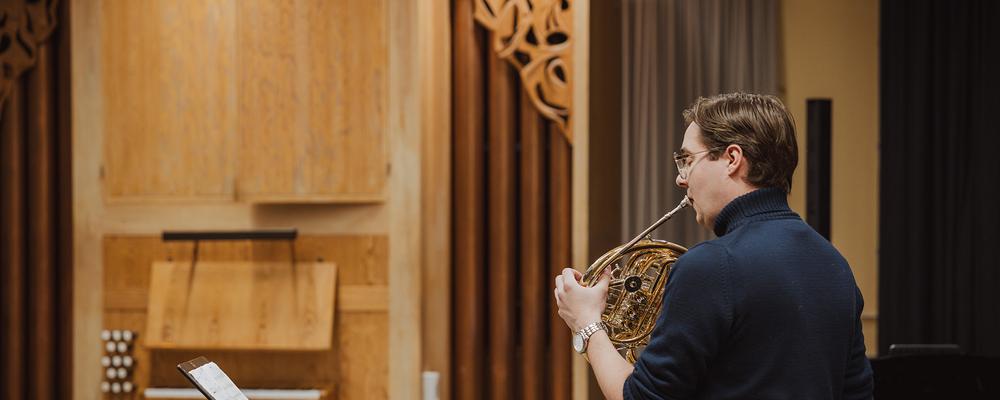 A person playing the French horn