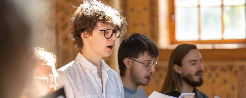 A group of people singing in a room