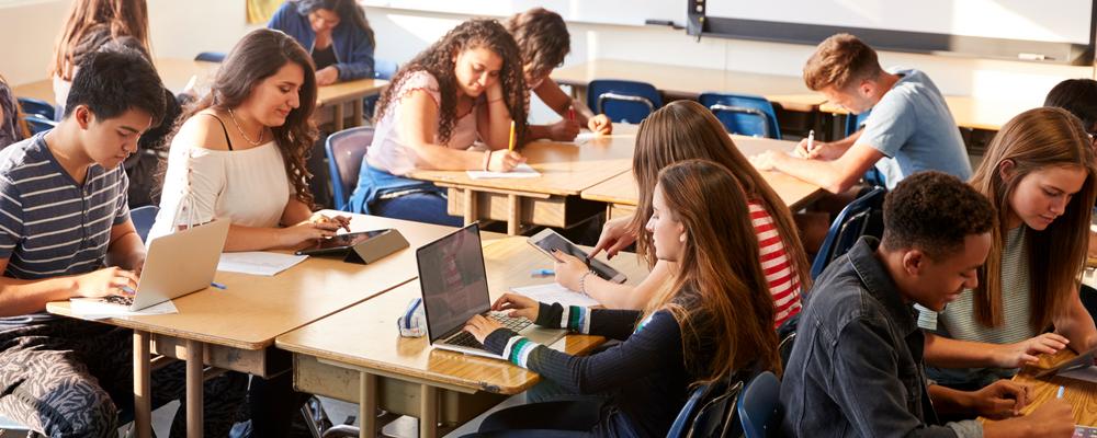 The picture shows a classroom of young people during a lesson.