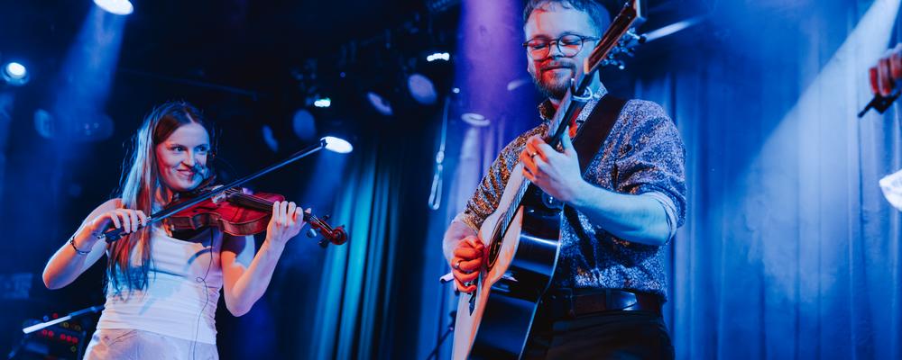 Two persons with musical instruments