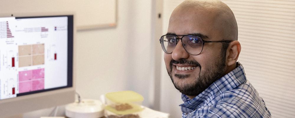Muhammad Arif at his office, in front of his computer. 