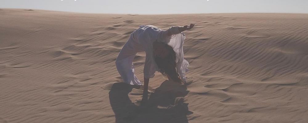 En person dansar i en öken