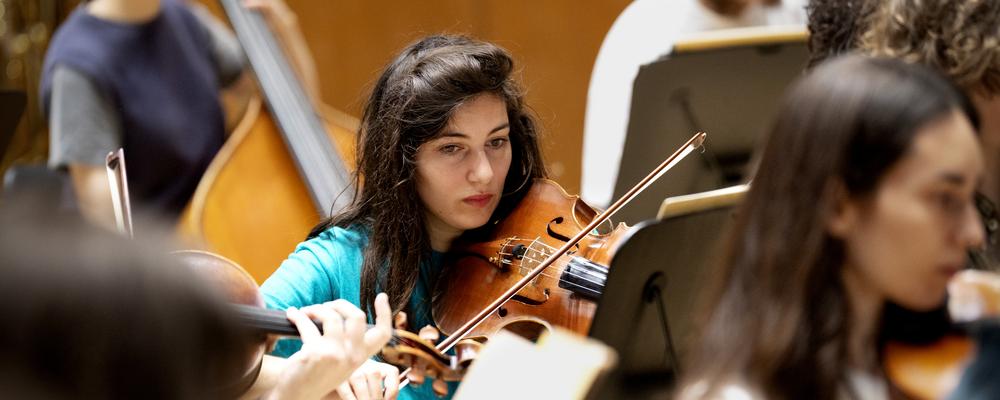 Several persons playing bowed string instruments