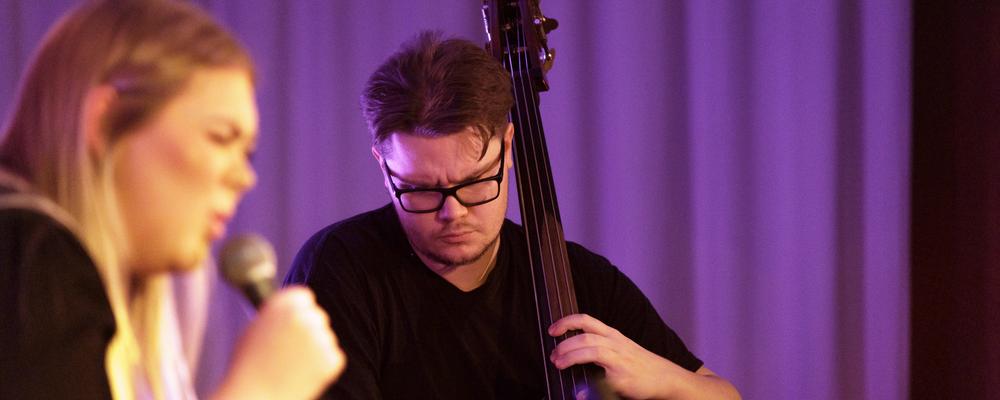 En person med kontrabas, en med mikrofon