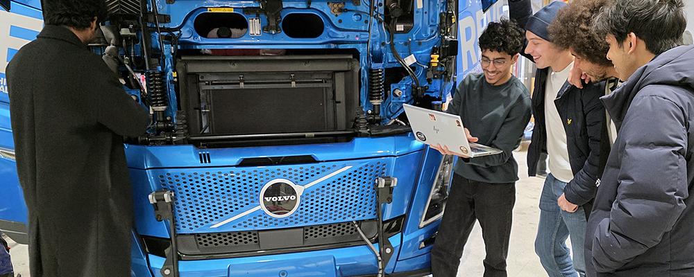 Software students in front the truck they are working on