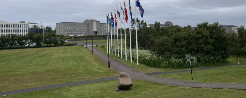 Vy över Reykjavik universitet, med nordiska flaggor i förgrunden.