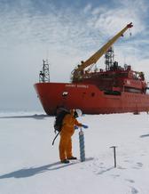 Louise Newman in front of research vessel Aurora. 