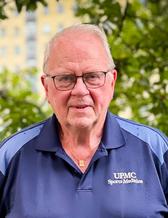 Jon, looking happy and relaxed outside.