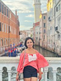 Kruthika Hanabhe standing on bridge in front of a canal in Venice. 