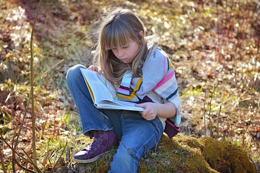 Girl reading in the forest
