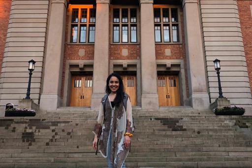 Alumna Devashree standing outside the main building of University of Gothenburg