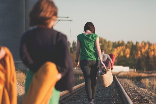 People walking on a railway track.