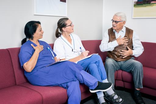 A patient and two healthcare professionals having a meeting.