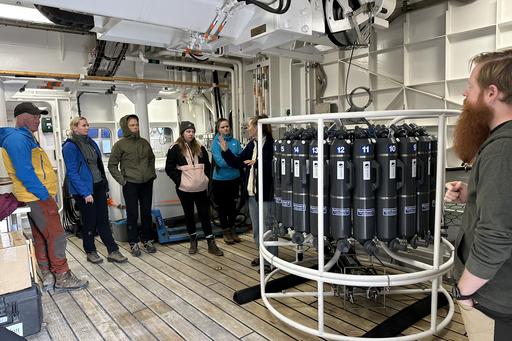 Researchers onboard the Skagerak look at instruments
